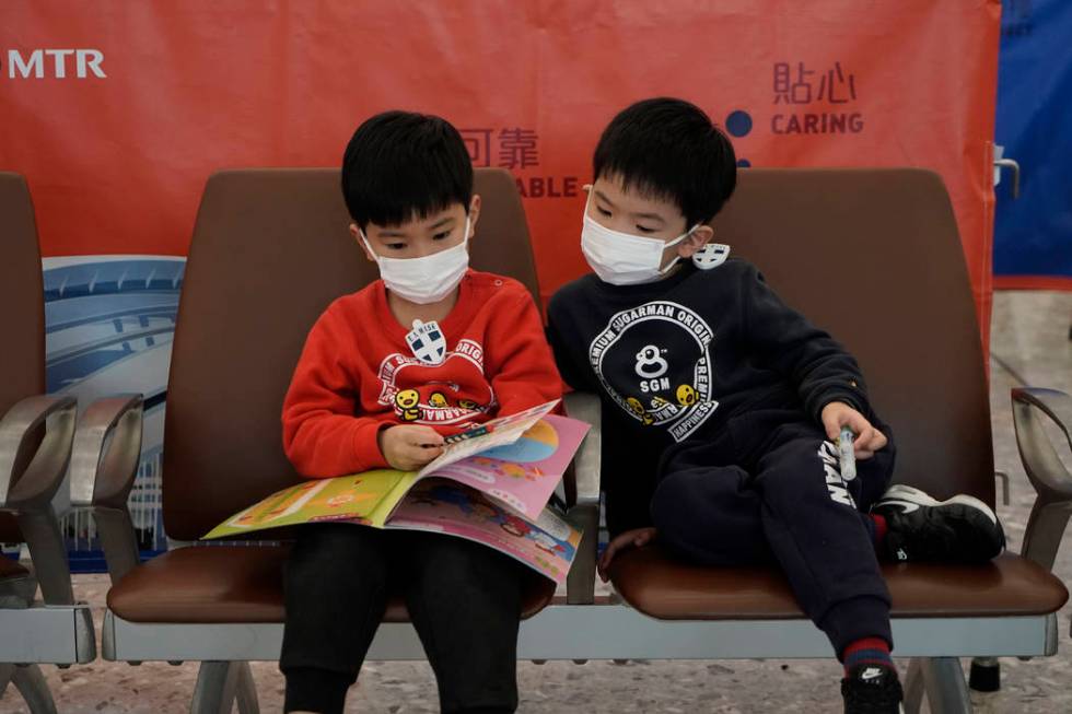 Passengers wear masks to prevent an outbreak of a new coronavirus in the high-speed train stati ...