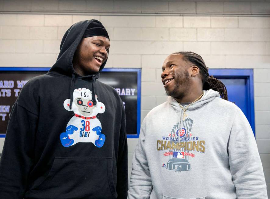 Desert Pines High School freshman and left tackle Rodney Leaks, left, speaks with assistant coa ...