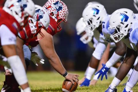 Liberty center Jeremiah Taiese (75) gets ready to snap the ball during a game against IMG Acade ...