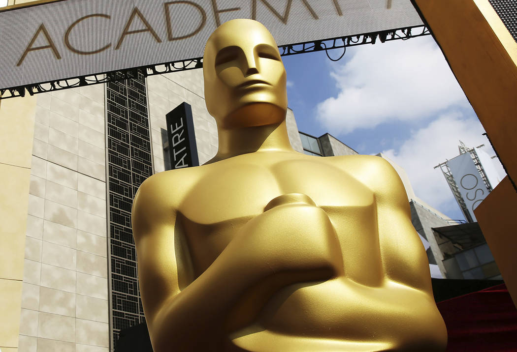 FILE - In this Feb. 21, 2015 file photo, an Oscar statue appears outside the Dolby Theatre for ...