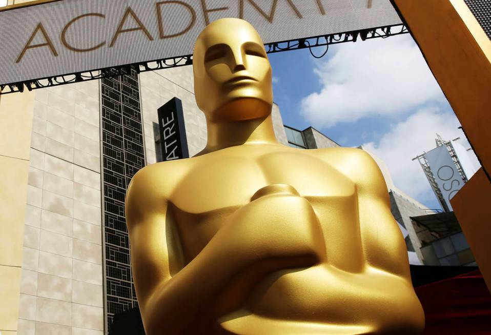 FILE - In this Feb. 21, 2015 file photo, an Oscar statue appears outside the Dolby Theatre for ...