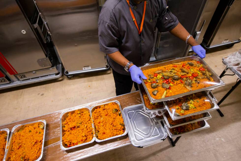 Sarif El-Amin, of Three Square food bank, packages vegan jambalaya and other surplus banquet fo ...