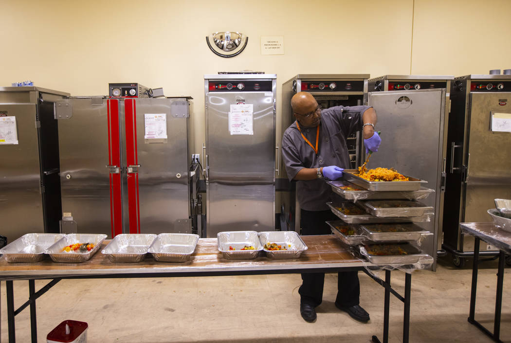 Sarif El-Amin, of Three Square food bank, packages vegan jambalaya and other surplus banquet fo ...