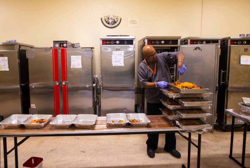 Sarif El-Amin, of Three Square food bank, packages vegan jambalaya and other surplus banquet fo ...