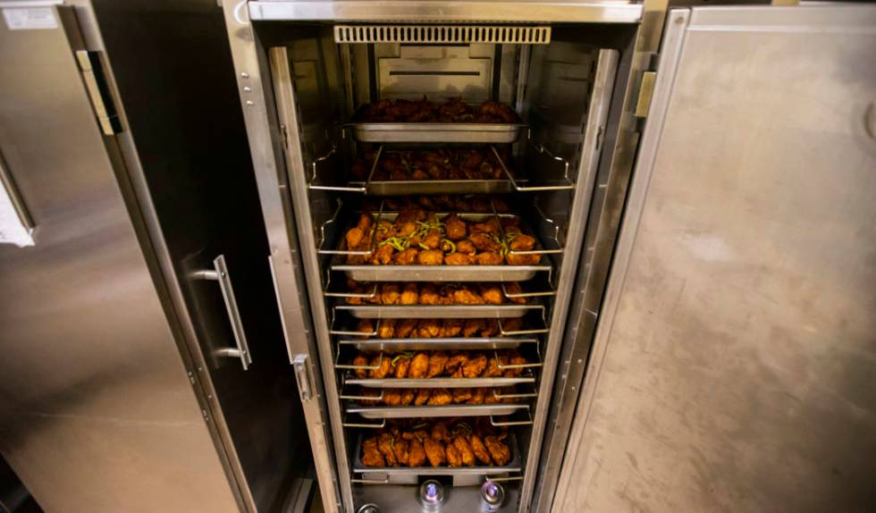 Racks of fried chicken to be donated to Three Square food bank, as part of the surplus banquet ...