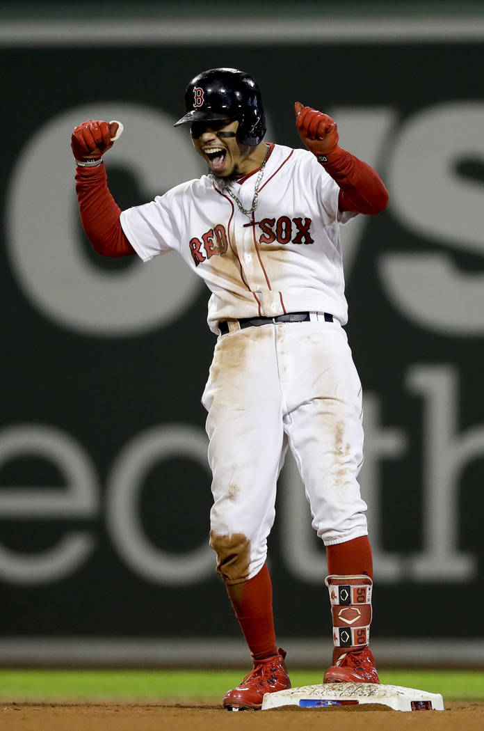 Boston Red Sox's Mookie Betts celebrates after his RBI-double against the Houston Astros during ...