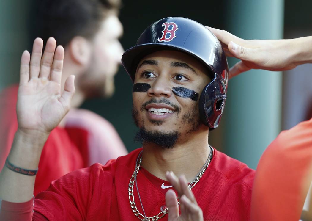 Boston Red Sox's Mookie Betts celebrates after scoring on a single by Brock Holt during the sec ...