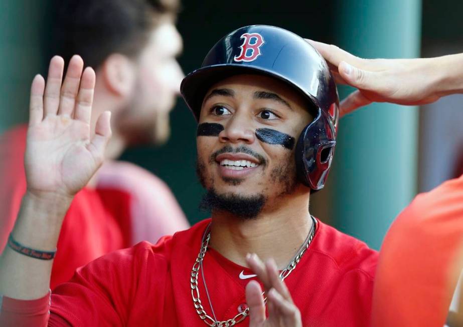 Boston Red Sox's Mookie Betts celebrates after scoring on a single by Brock Holt during the sec ...