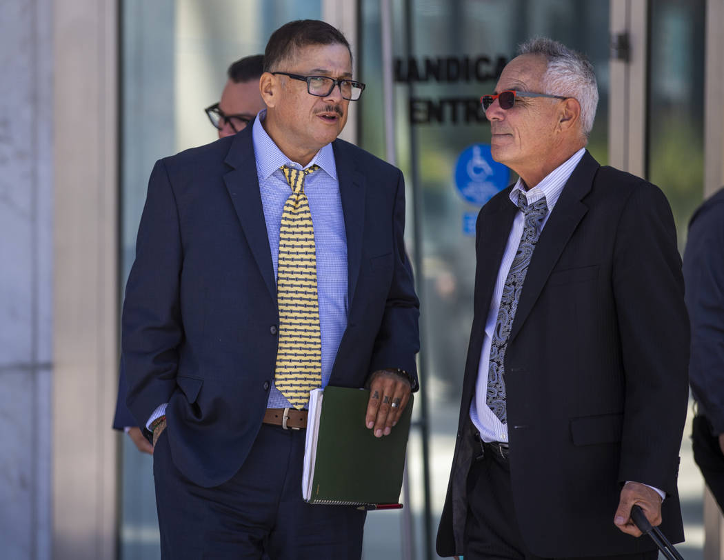 Defendant Cesar Morales, left, talks with counselor Shawn Perez outside the Lloyd D. George Cou ...