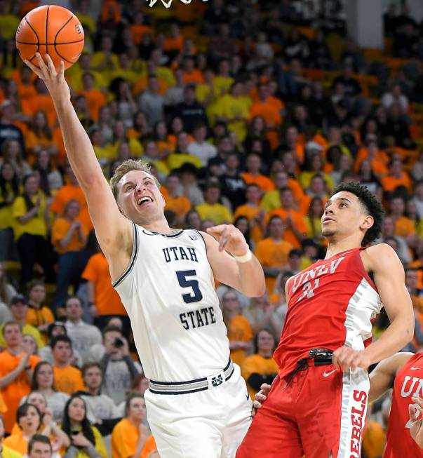 Utah State guard Sam Merrill, left, celebrates after forcing a jump ball against UNLV guard Bry ...