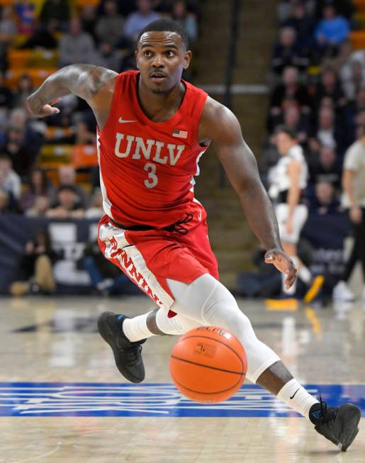 UNLV guard Marvin Coleman (31) fouls Utah State forward Justin Bean during the second half of a ...