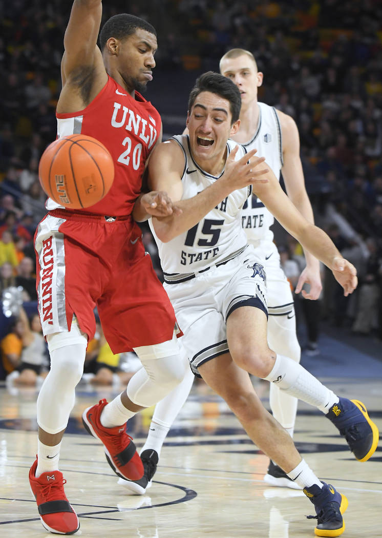 Utah State guard Abel Porter (15) loses control of the ball as UNLV forward Nick Blair (20) def ...