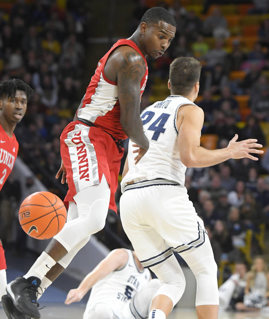 UNLV guard Elijah Mitrou-Long (55) knocks the ball out of the hands of Utah State guard Abel Po ...