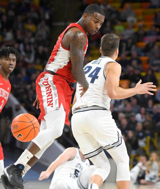 UNLV guard Elijah Mitrou-Long (55) knocks the ball out of the hands of Utah State guard Abel Po ...