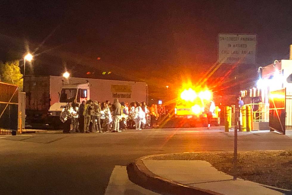 People stand outside the Amazon North Las Vegas fulfillment center after a fire Tuesday, Feb. 4 ...