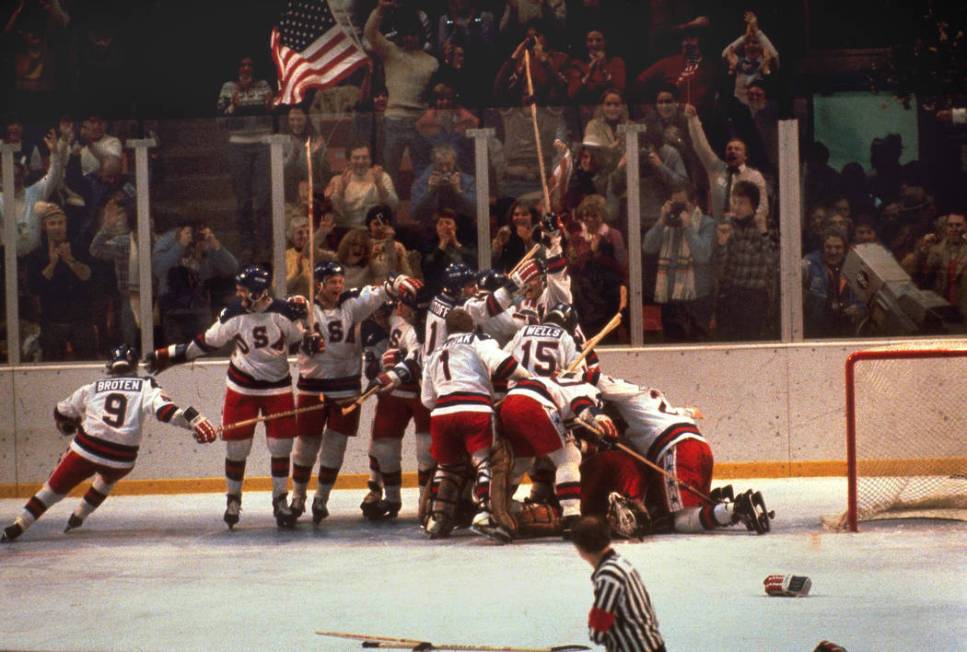 FILE -In this Feb. 22, 1980 file photo, the U.S. hockey team pounces on goalie Jim Craig after ...