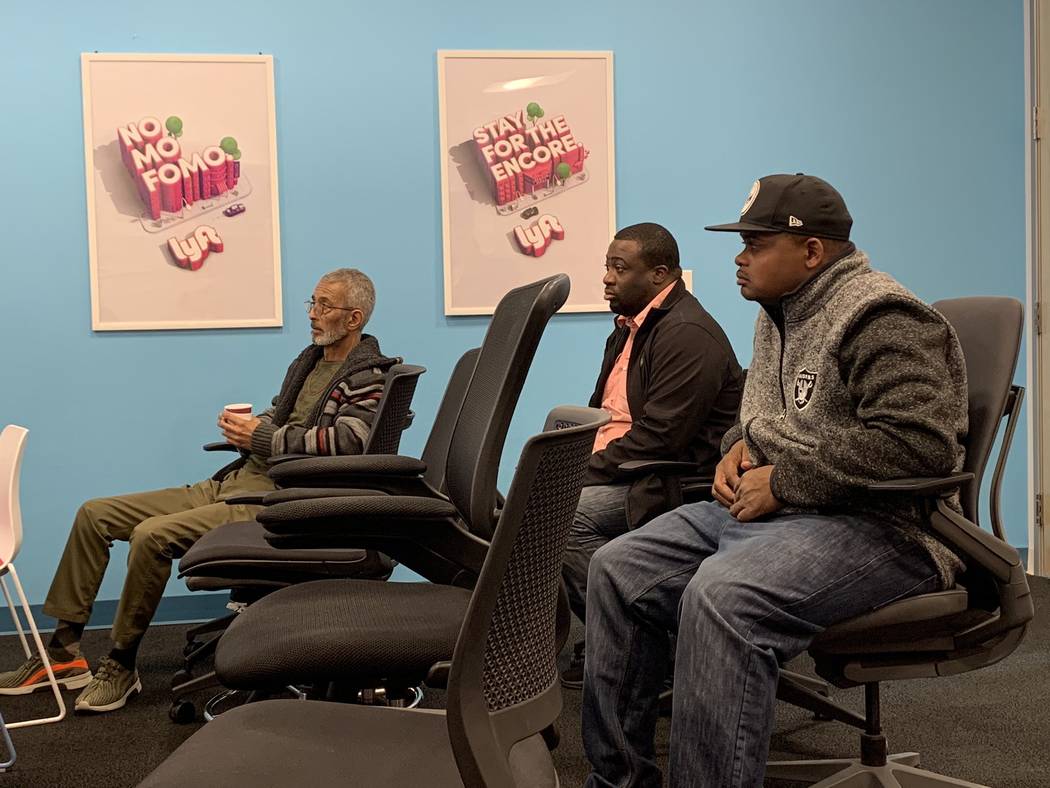 Lyft drivers Joseph Rightious, Oneil Cassells and Herman Stephans watch a presentation about hu ...