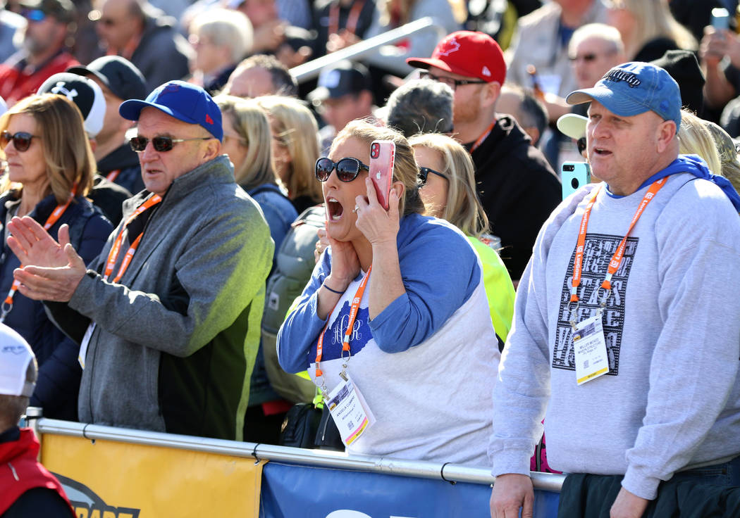 Angela Cummins, center, and Miller McKee, right, cheer during the 2020 Spec Mix Bricklayer 500 ...
