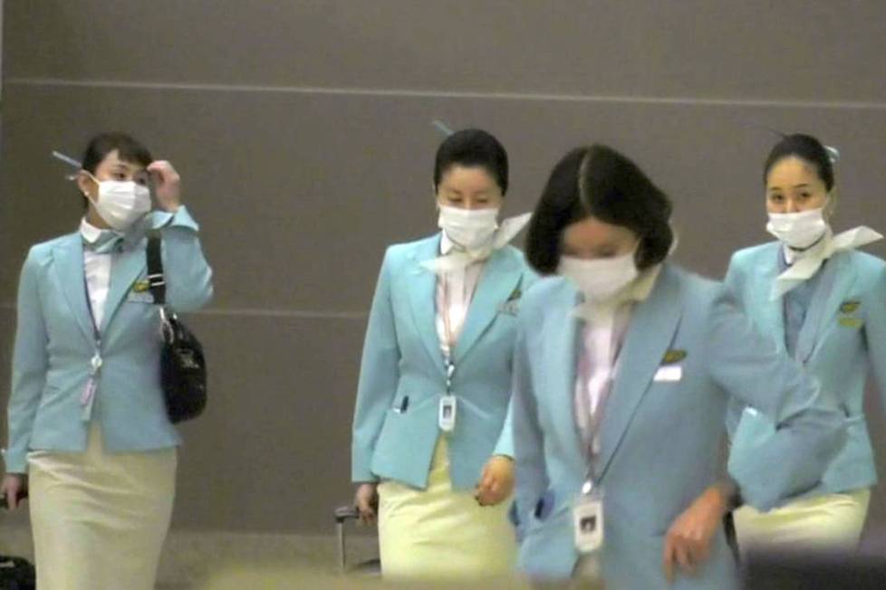 Korean Air workers leave Flight 005 after landing at McCarran International Airport in Las Vega ...