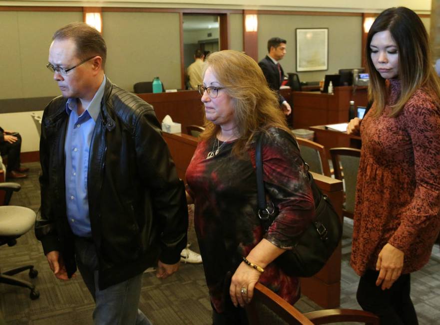 Theresa Christensen, center, mother of Lee's Liquor murder victim Matthew Christensen, 24, and ...