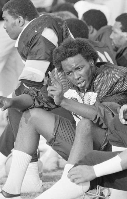 Oakland Raiders quarterback Lester Hayes is shown holding up the victory sign during practice ...