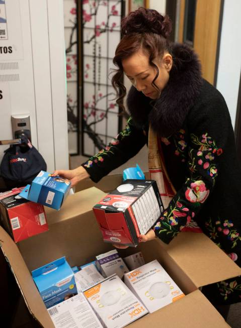 Suying Chen, a member of the Nevada Chinese Association, counts medical supplies to be sent to ...