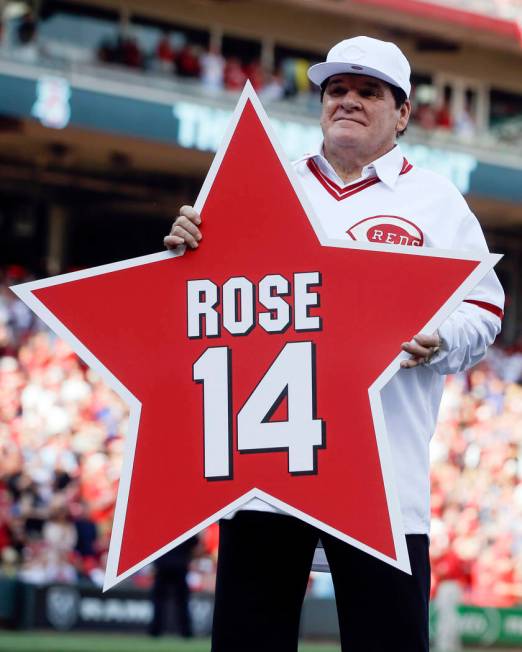 FILE -In this June 24, 2016, file photo, former Cincinnati Reds player Pete Rose (14) holds his ...