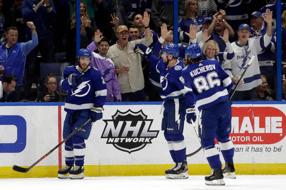 Tampa Bay Lightning center Brayden Point (21) celebrates with center Steven Stamkos (91) and ri ...