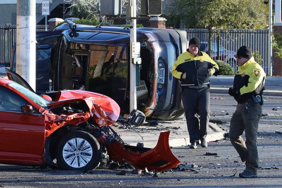 Metropolitan Police Department officers investigate a two-vehicle rollover at South Jones Boule ...