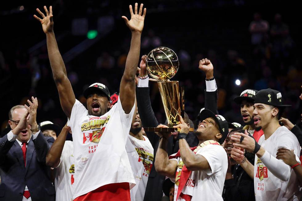 Toronto Raptors center Serge Ibaka, left, guard Kyle Lowry, center, and guard Danny Green celeb ...