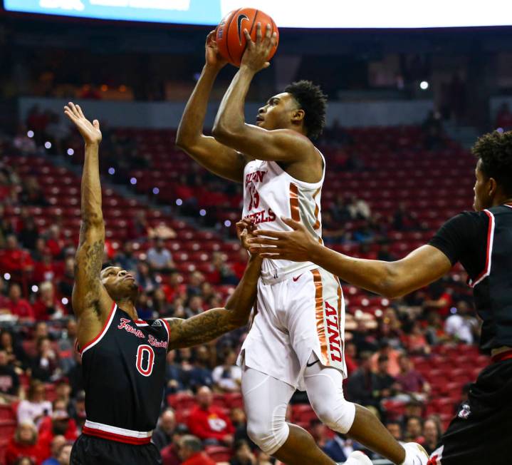 UNLV's Bryce Hamilton (13) shoots over Fresno State's New Williams (0) during the first half of ...