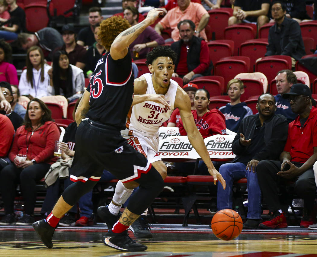 UNLV's Marvin Coleman (31) drives to the basket against Fresno State's Noah Blackwell (55) duri ...