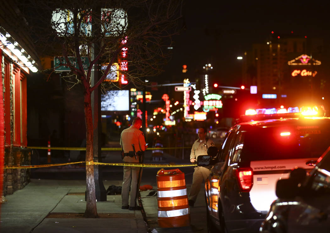 Las Vegas police officers investigate the scene of a shooting on Fremont Street between 14th an ...