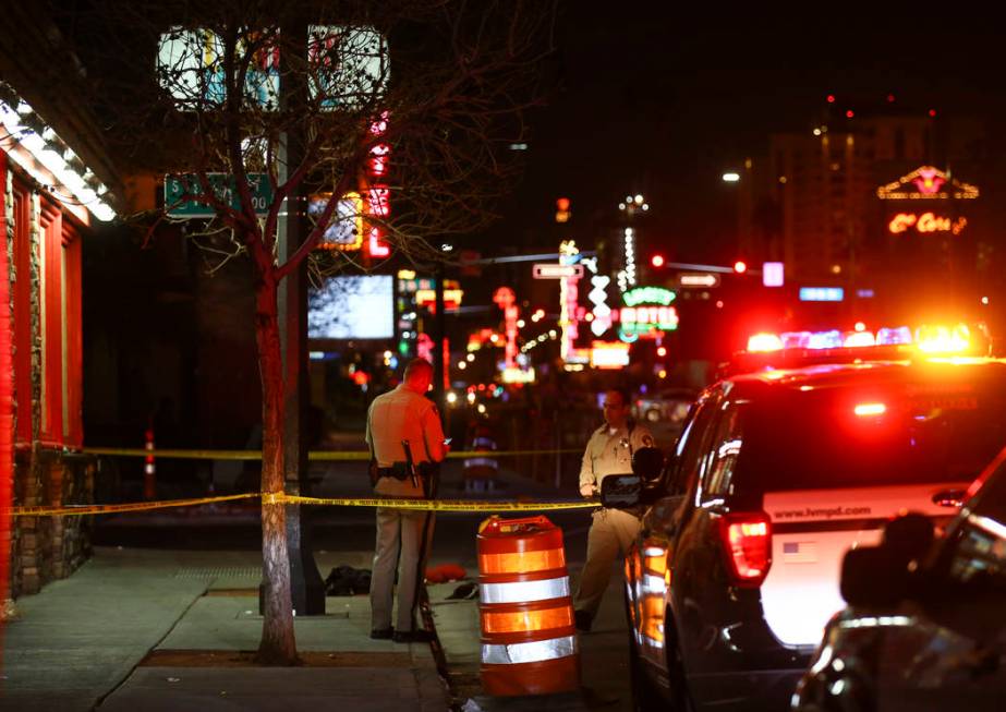 Las Vegas police officers investigate the scene of a shooting on Fremont Street between 14th an ...