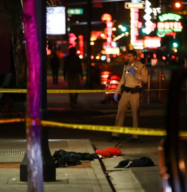 Las Vegas police officers investigate the scene of a shooting on Fremont Street between 14th an ...