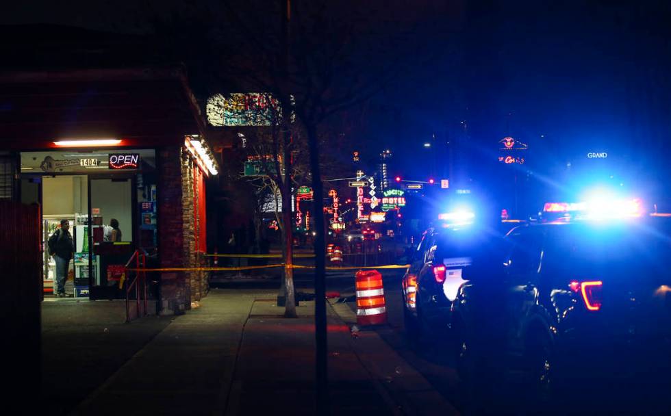 Las Vegas police officers investigate the scene of a shooting on Fremont Street between 14th an ...