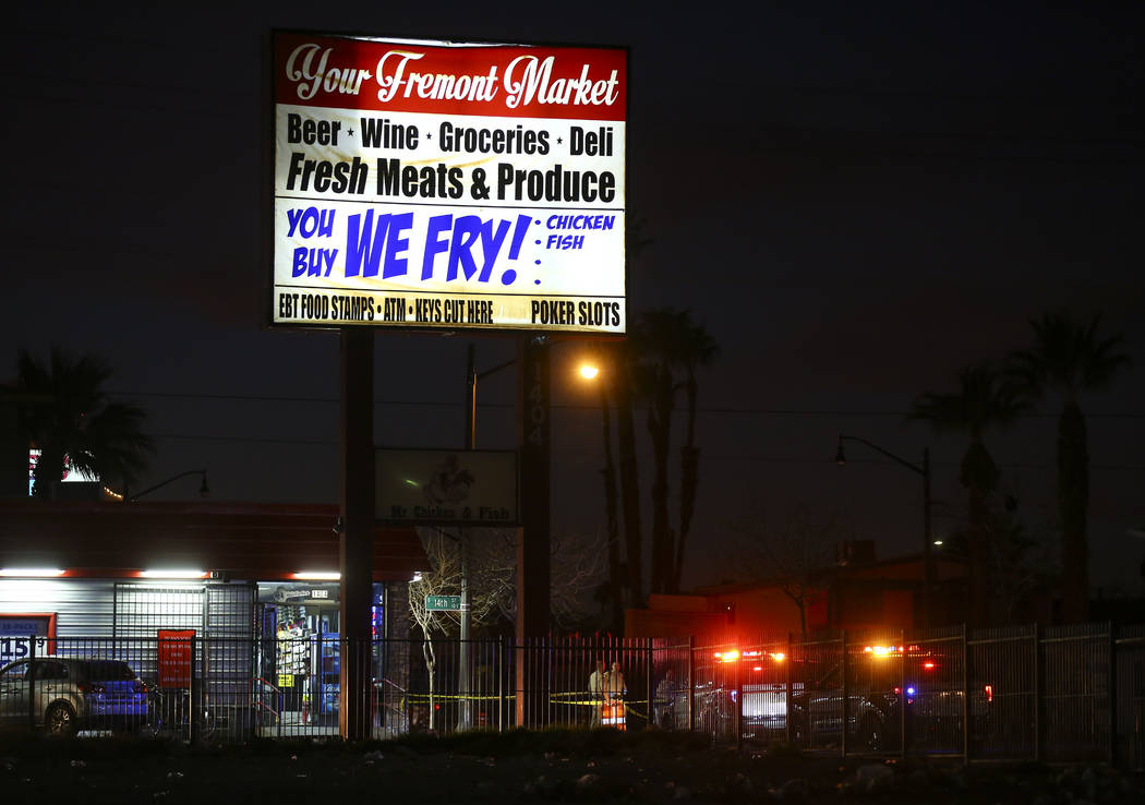 Las Vegas police officers investigate the scene of a shooting on Fremont Street between 14th an ...