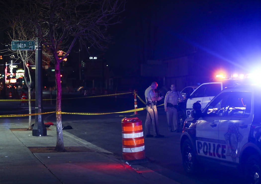 Las Vegas police officers investigate the scene of a shooting on Fremont Street between 14th an ...