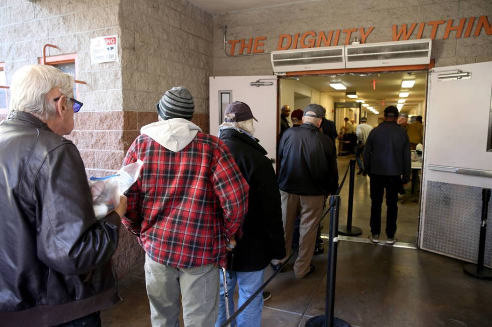 People line up for the overnight shelter beds at Catholic Charities in Las Vegas Thursday, Feb. ...