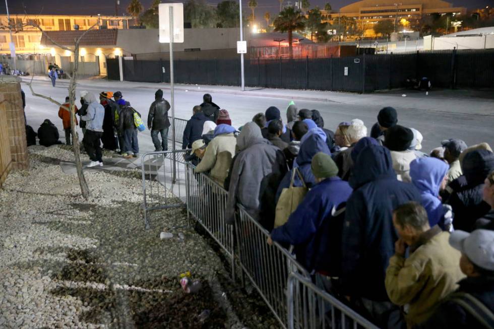 People line up for the overnight shelter beds at Catholic Charities in Las Vegas Thursday, Feb. ...