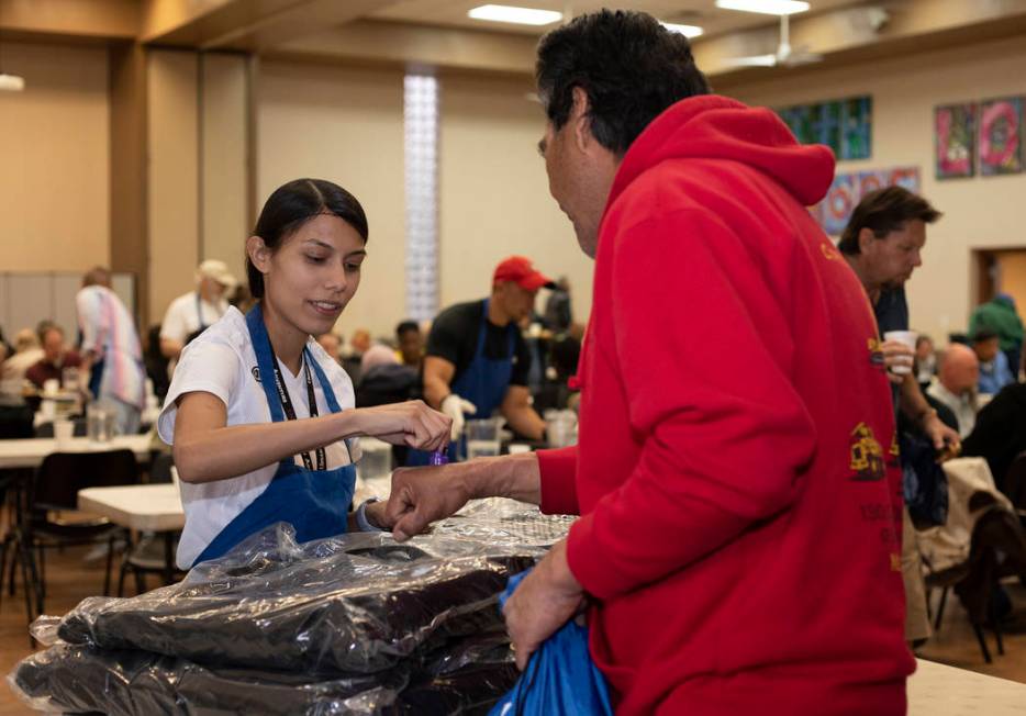 Volunteer Vicky Castellanos hands out CITYPAK backpacks at the Las Vegas Rescue Mission on Satu ...
