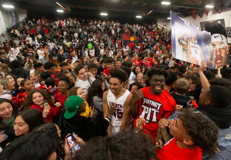 Liberty fans rush the court after the Patriots defeated Coronado on Friday, February 7, 2020, a ...