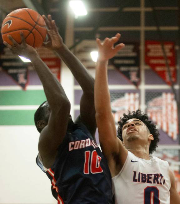 Liberty senior guard Julian Strawther (0) contests the shot of Coronado senior guard Tyrelle Hu ...