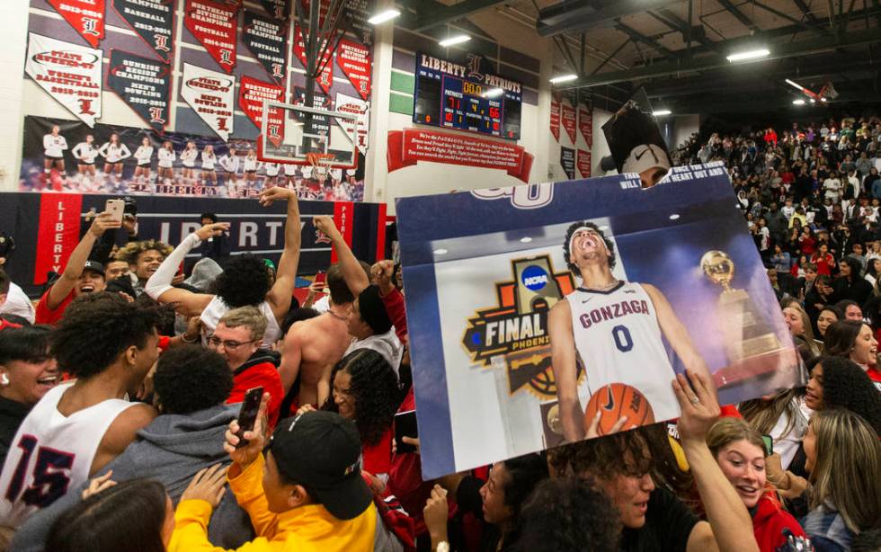 Liberty fans rush the court after the Patriots defeated Coronado on Friday, February 7, 2020, a ...