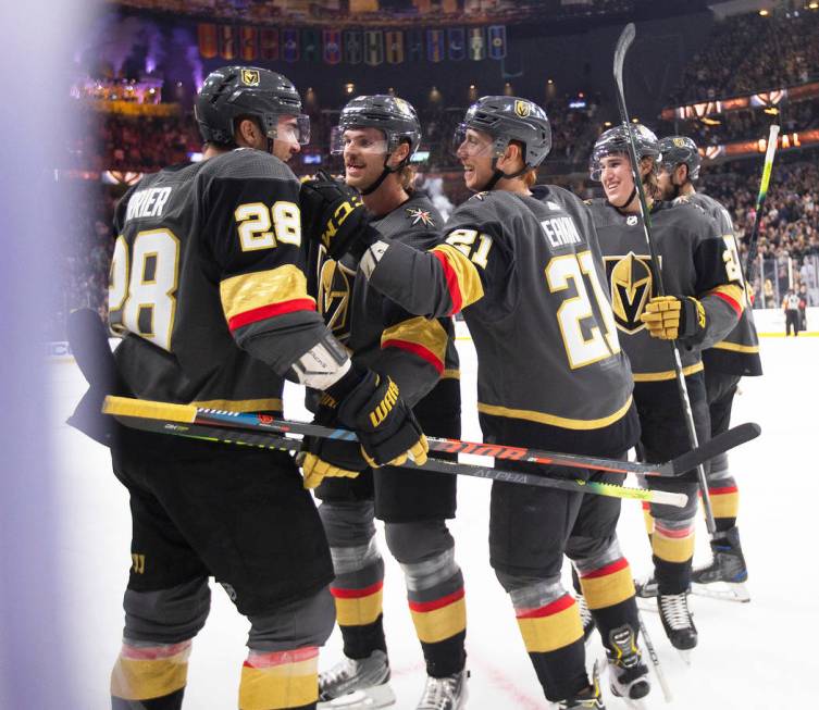 Vegas Golden Knights left wing William Carrier (28), Vegas Golden Knights defenseman Jon Merril ...