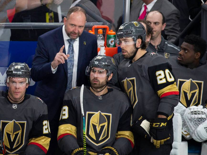 Golden Knights head coach Peter DeBoer talks with Vegas Golden Knights center Chandler Stephens ...