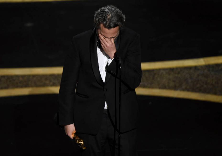 Joaquin Phoenix reacts as he accepts the award for best performance by an actor in a leading ro ...