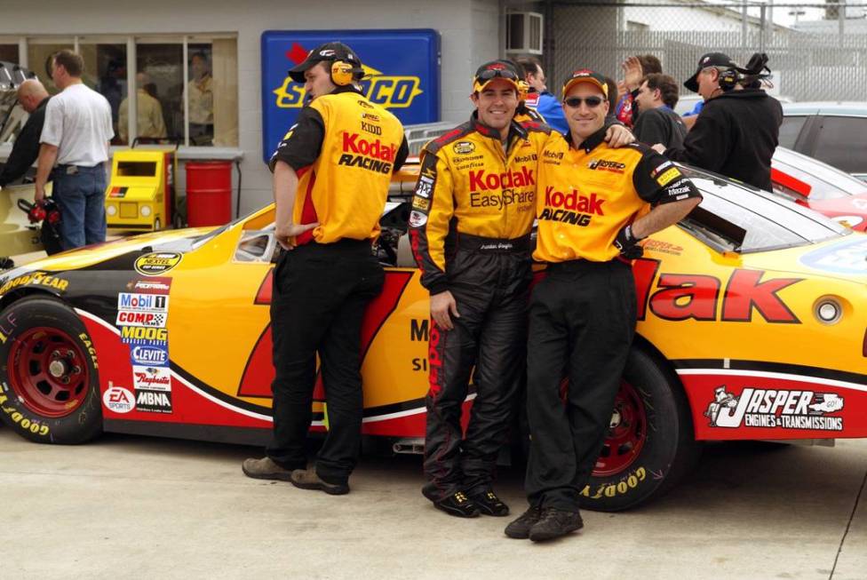 NASCAR Nextel Cup Series driver Brendan Gaughan of Las Vegas, center, poses with his engine tun ...