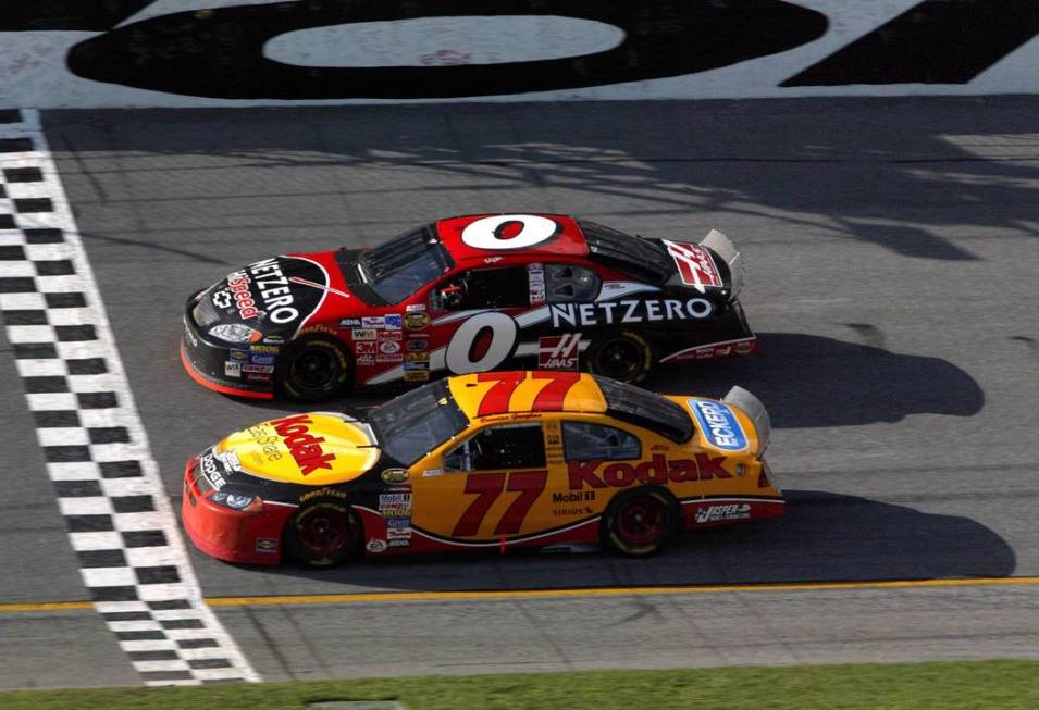 Las Vegan Brendan Gaughan, 77, crosses the start/finish line with Ward Burton, 0, during his fi ...