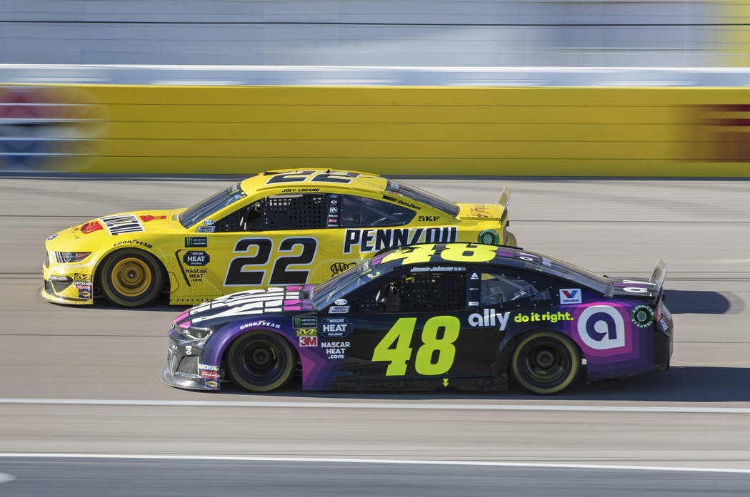 Joey Logano (22) passes Jimmie Johnson (48) in the final laps of the Monster Energy NASCAR Cup ...